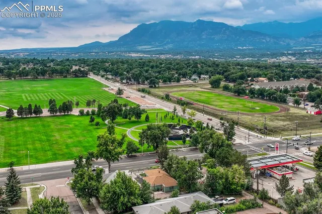 a view of a lush green hillside and houses