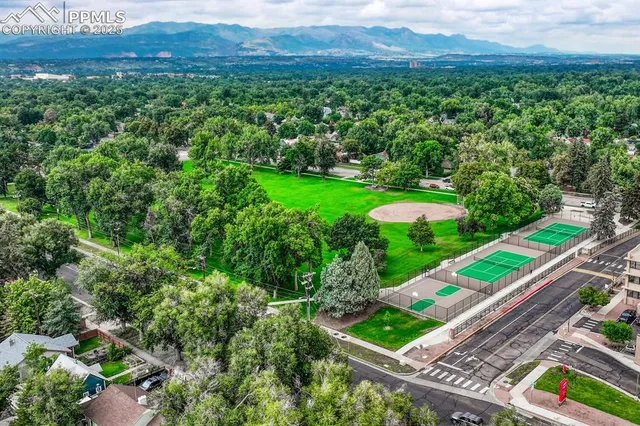 a view of a lush green forest with a houses