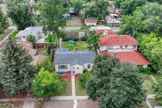 an aerial view of a house with yard and outdoor seating