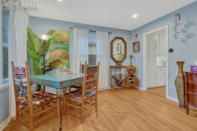 a view of a room with furniture and wooden floor