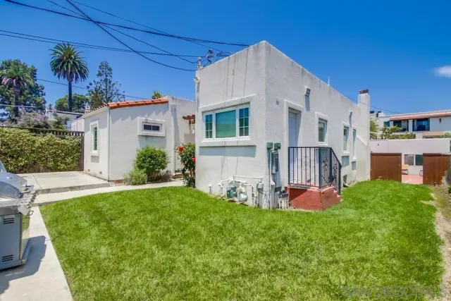a view of a house with potted plants