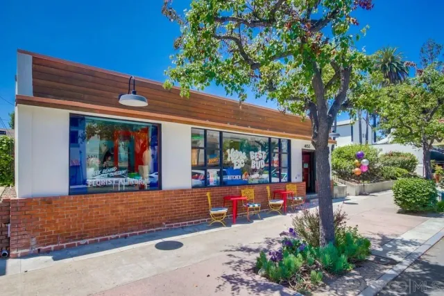 a living room with lots of furniture and a large window