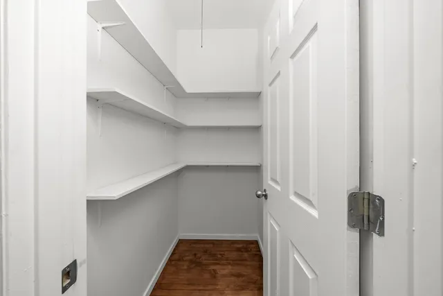 a view of a storage and utility room with washer and dryer