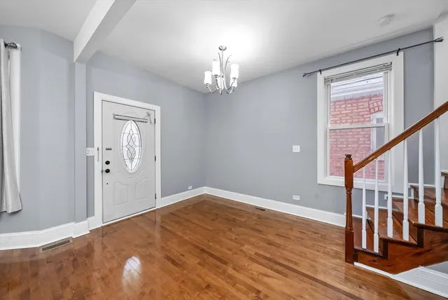 a kitchen with granite countertop stainless steel appliances and wooden floor