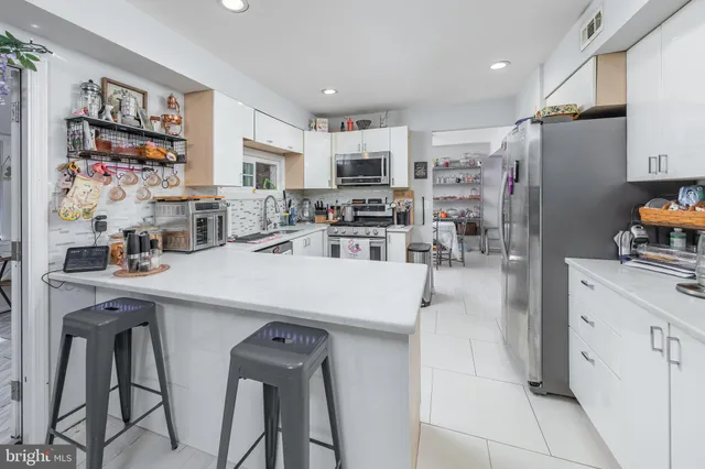 a kitchen with stainless steel appliances a refrigerator and cabinets