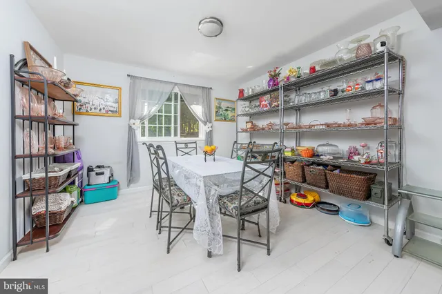 a dining room with a wooden table and chairs