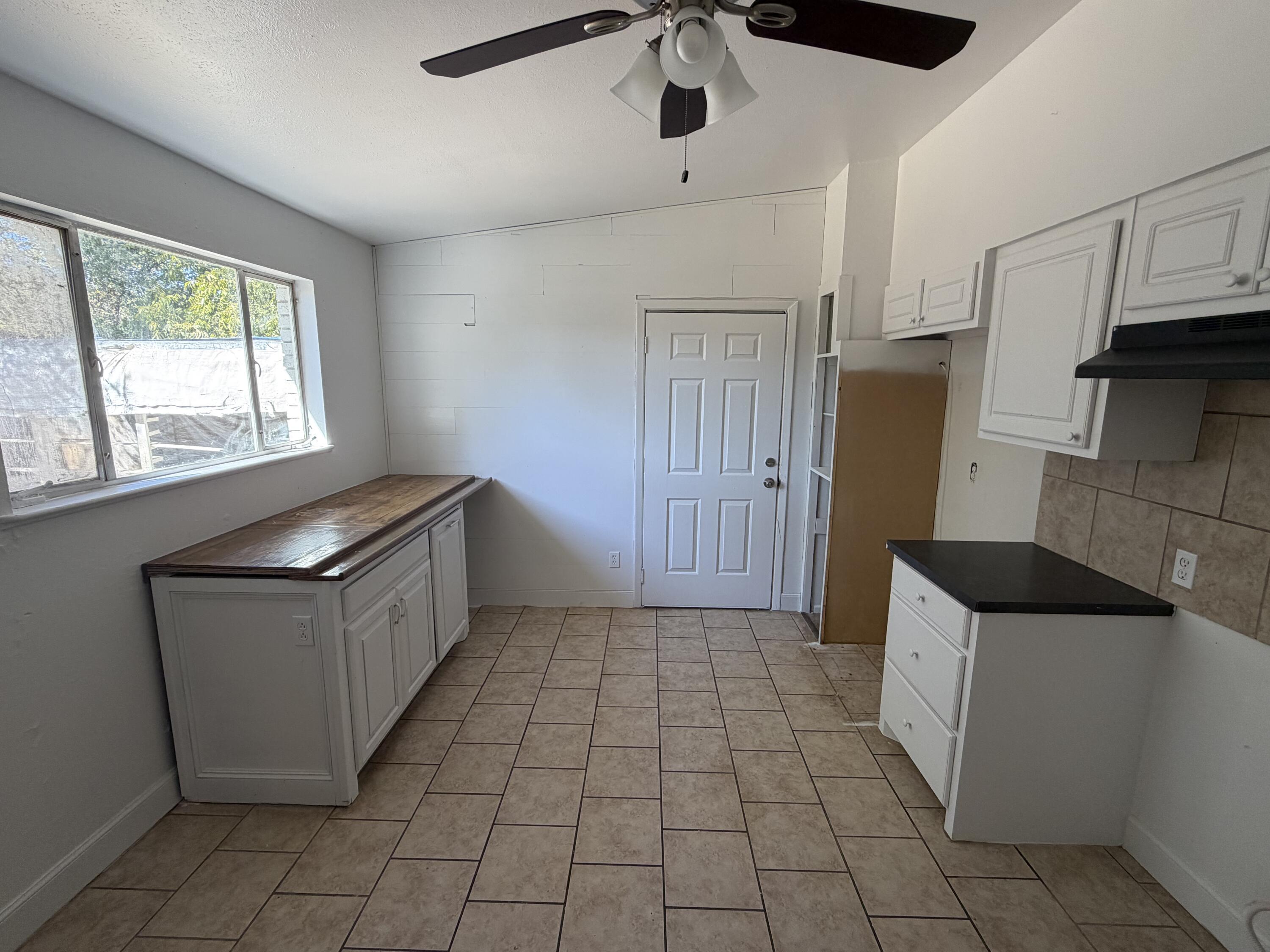 6004 Peoria Avenue Lubbock, TX 79413 - Photo 4 of 7 a kitchen with a refrigerator a sink and cabinets
