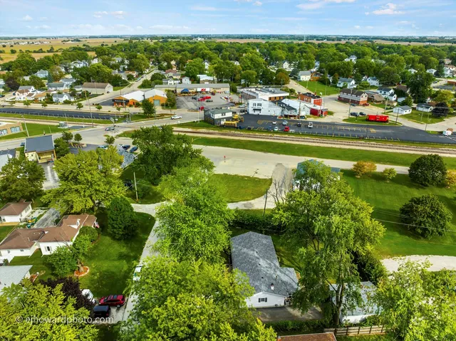 an aerial view of a house with a yard