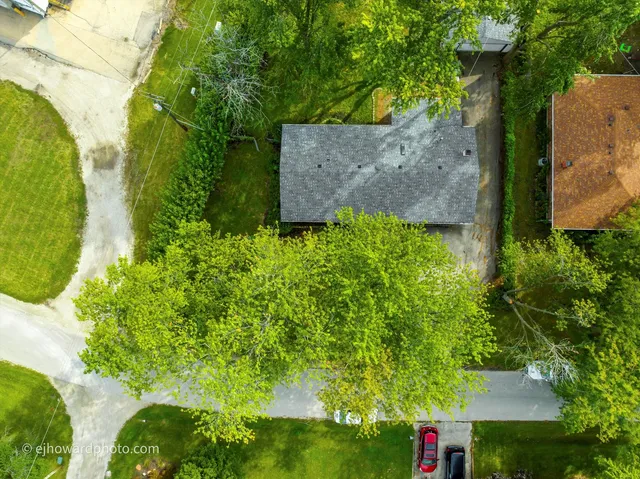 an aerial view of a house with a yard