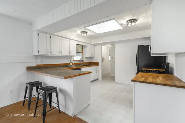a kitchen with stainless steel appliances granite countertop a sink and a stove