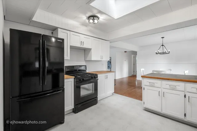 a kitchen with granite countertop stainless steel appliances and wooden cabinets