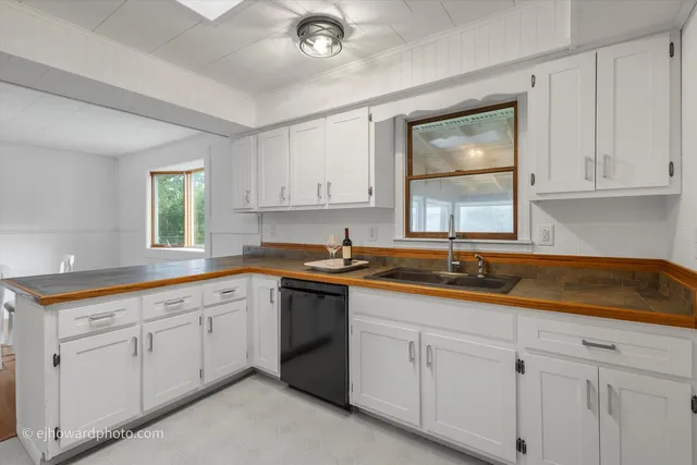 a kitchen with sink and cabinets