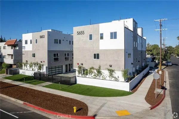 a aerial view of a house with a yard and garage