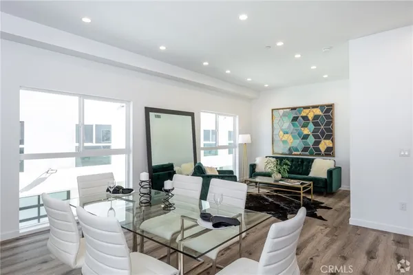 a living room with furniture and large windows