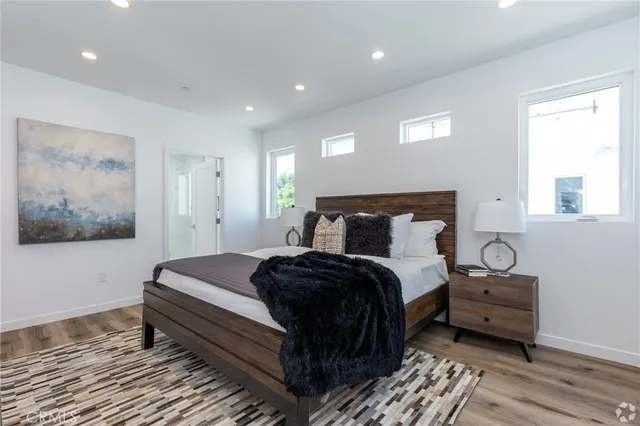 a bedroom with a bed and a painting