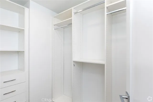 a close view of closet with white walls
