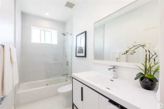 a bathroom with a sink a toilet and bathtub