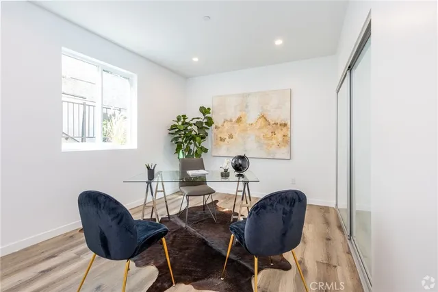 a view of a workspace room with furniture and a potted plant