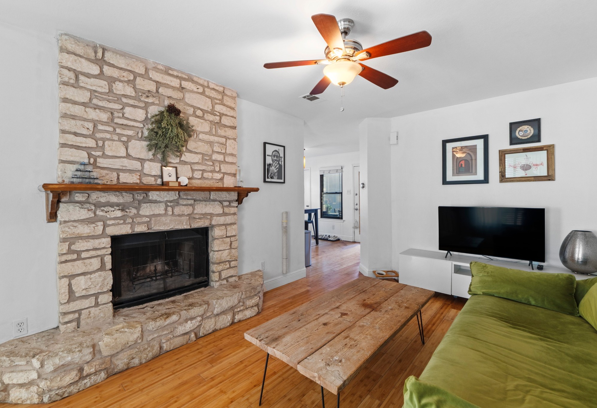 1750 Timber Ridge Road, Unit 102 Austin, TX 78741 - Photo 12 of 24 a living room with furniture a flat screen tv and a fireplace