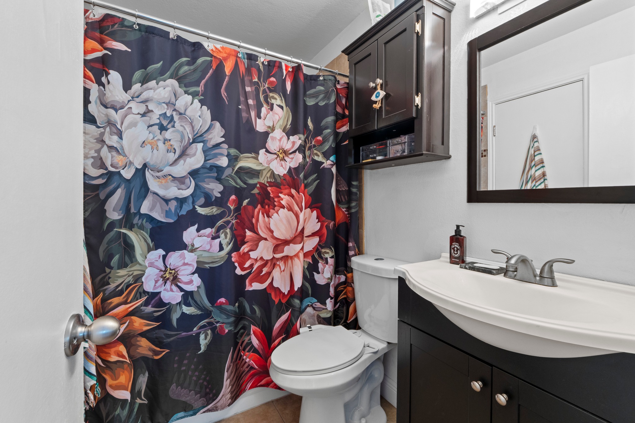 1750 Timber Ridge Road, Unit 102 Austin, TX 78741 - Photo 16 of 24 a bathroom with a toilet sink and mirror