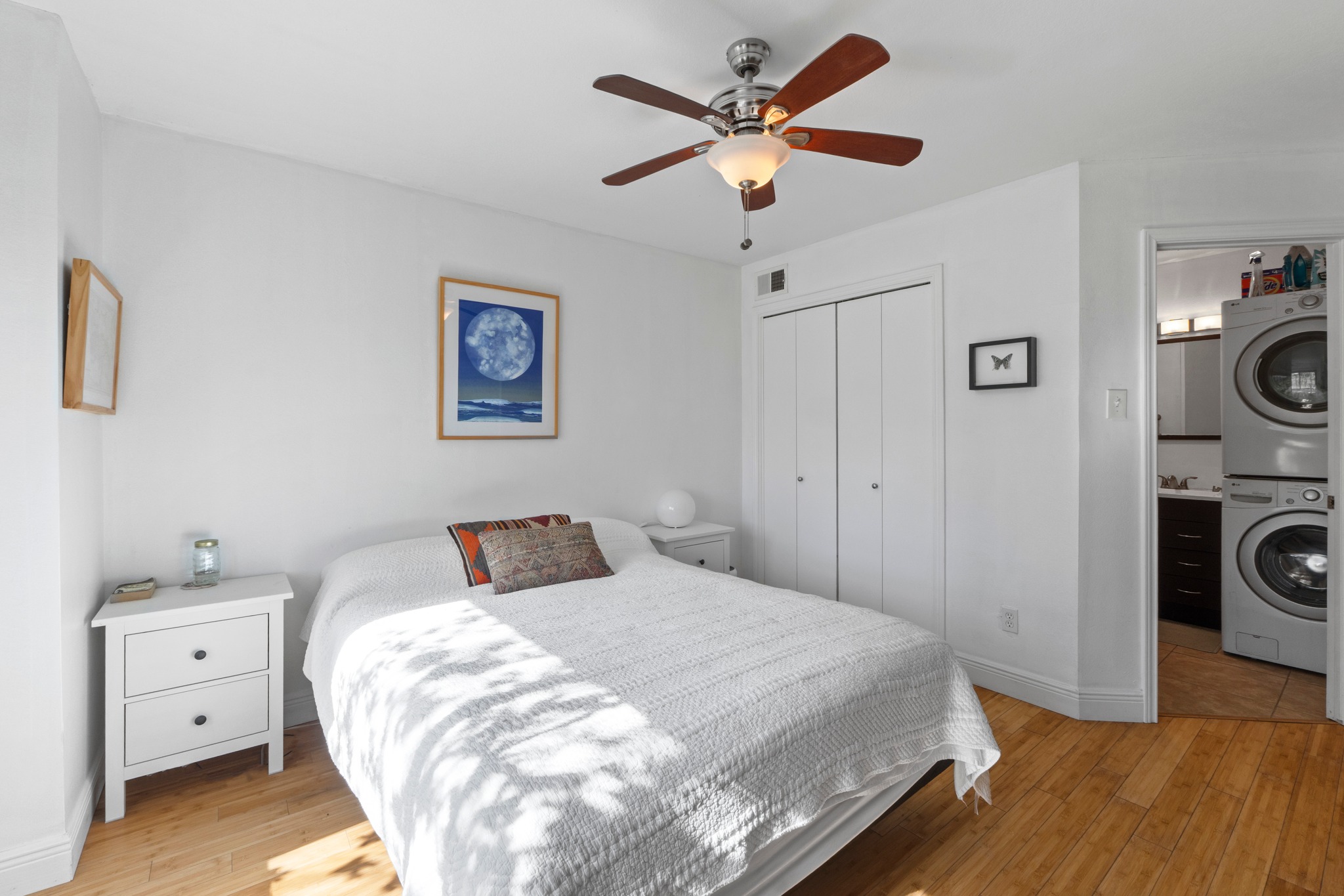 1750 Timber Ridge Road, Unit 102 Austin, TX 78741 - Photo 8 of 24 a bedroom with a white bed and a chandelier