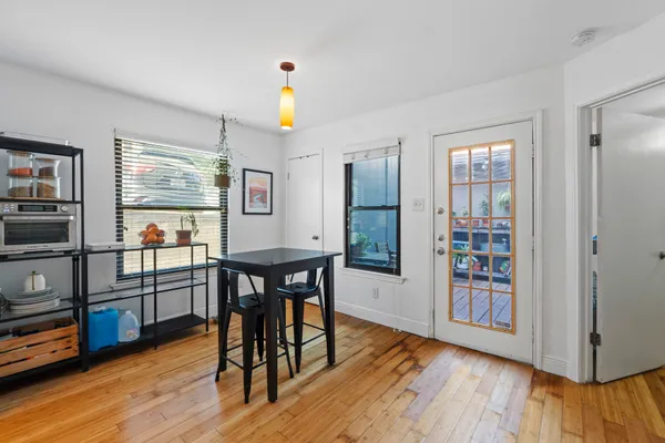 a view of a dining room with furniture and wooden floor