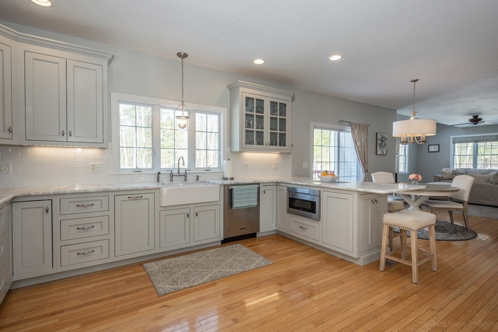5 Nelson Court Mendon, MA 01756 - Photo 14 of 41 a kitchen with sink cabinets and wooden floor