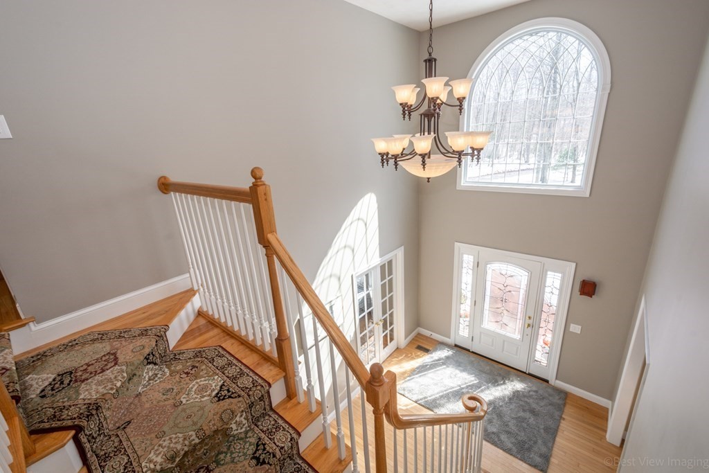 5 Nelson Court Mendon, MA 01756 - Photo 19 of 41 a view of staircase with wooden floor and a chandelier