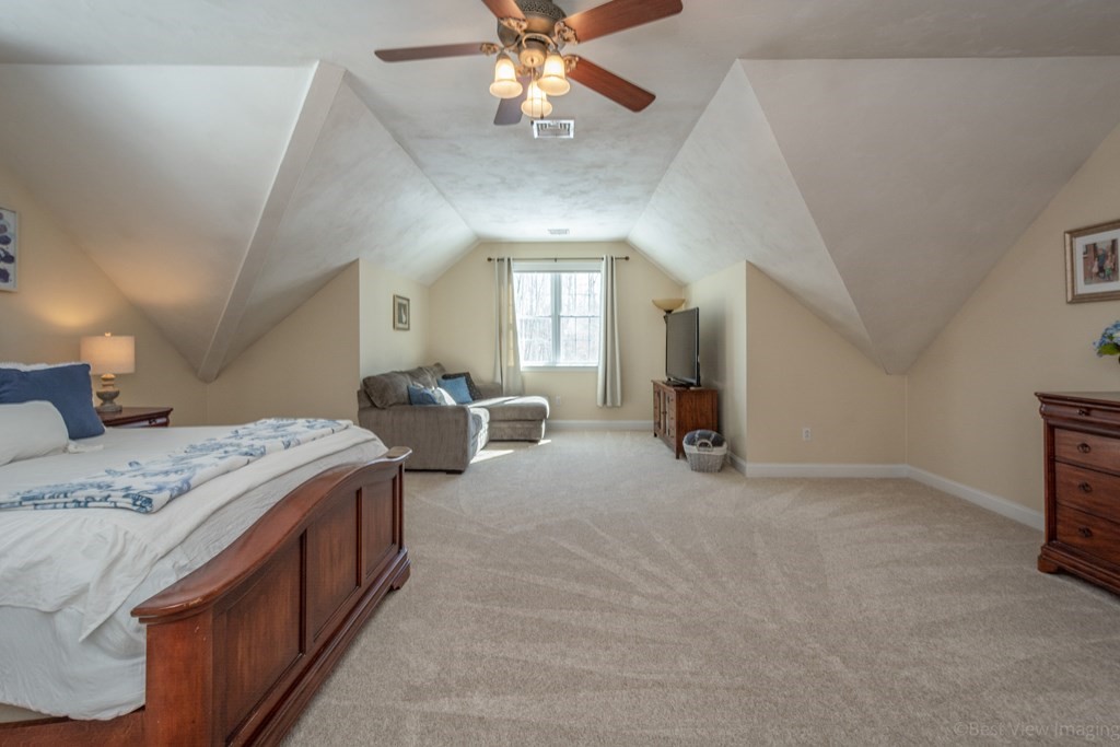 5 Nelson Court Mendon, MA 01756 - Photo 21 of 41 a spacious bedroom with a bed and a chandelier