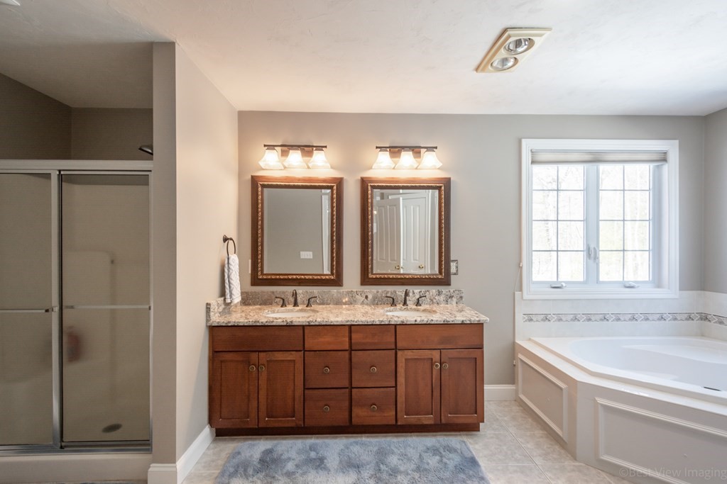 5 Nelson Court Mendon, MA 01756 - Photo 23 of 41 a bathroom with a granite countertop double vanity sink a mirror and a bathtub