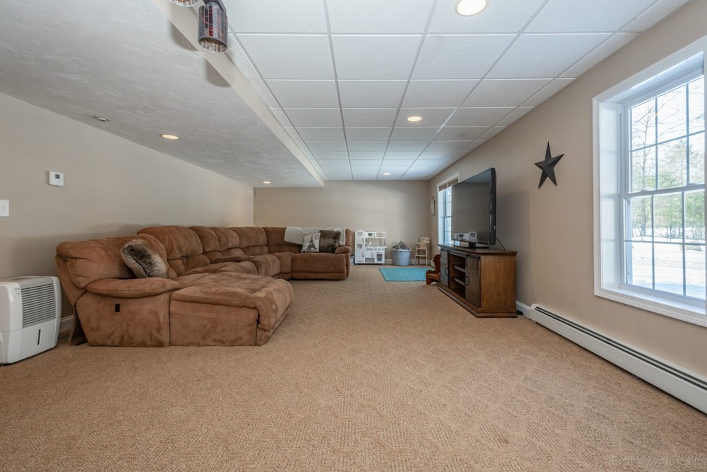 5 Nelson Court Mendon, MA 01756 - Photo 33 of 41 a living room with furniture a flat screen tv and windows