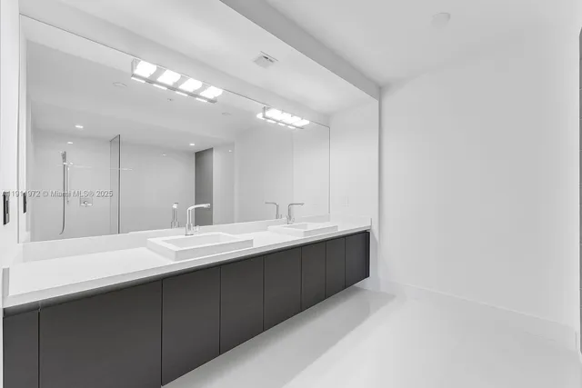 a large bathroom with a double vanity sink and a mirror