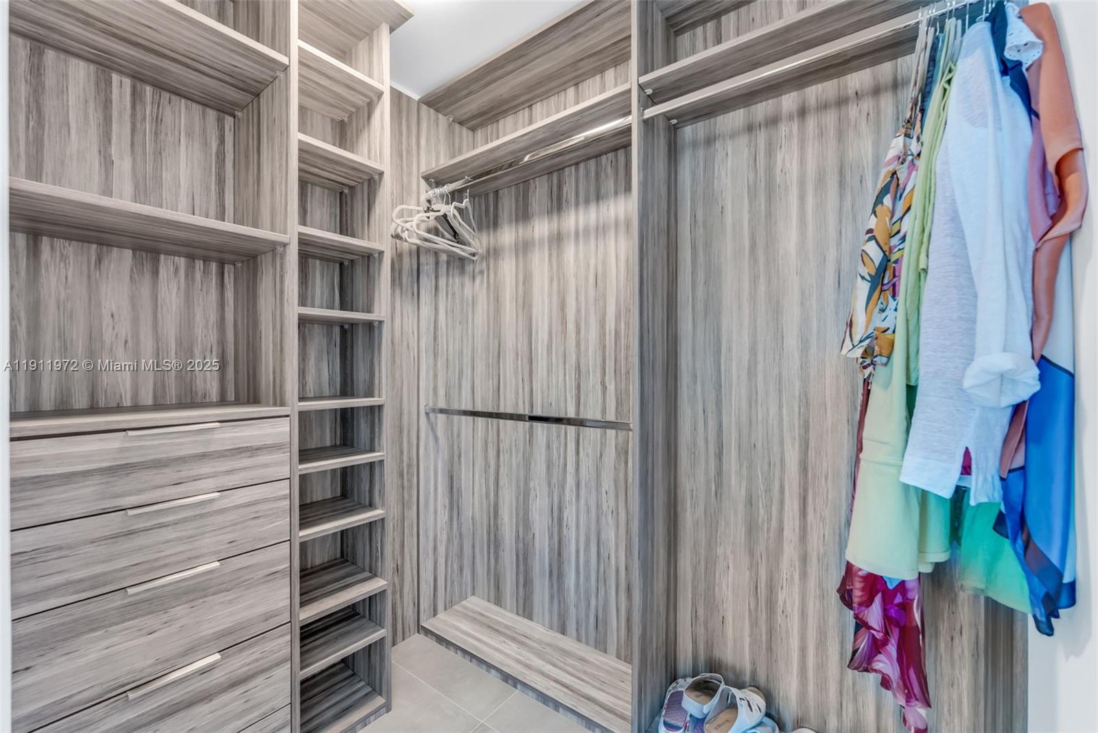 300 Sunny Isles Boulevard, Unit 4905 Sunny Isles Beach, FL 33160 - Photo 13 of 35 a view of walk in closet with clothes and shoes