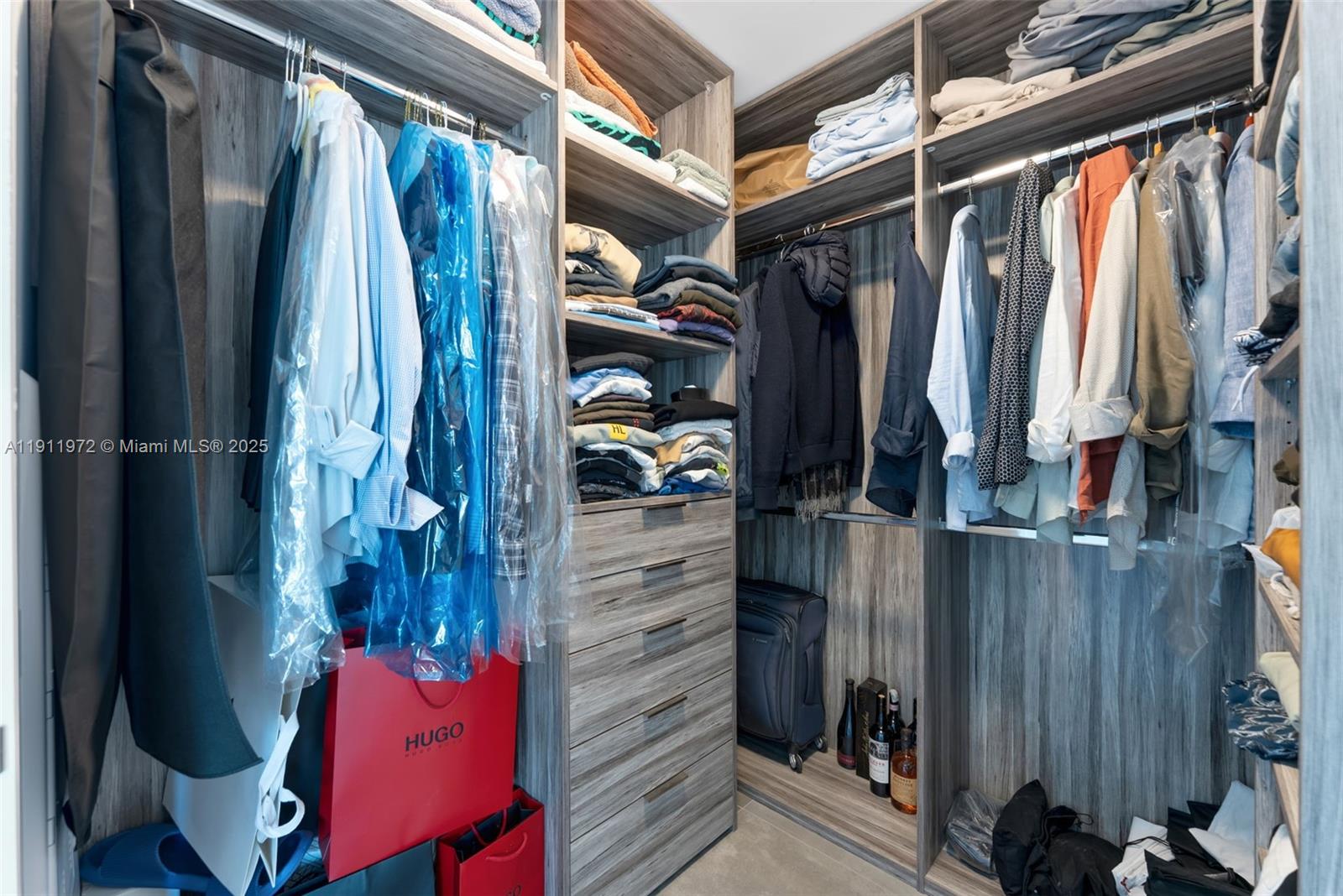 300 Sunny Isles Boulevard, Unit 4905 Sunny Isles Beach, FL 33160 - Photo 14 of 35 a view of walk in closet with clothes and shoes