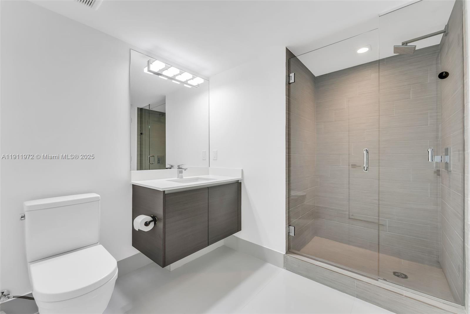 300 Sunny Isles Boulevard, Unit 4905 Sunny Isles Beach, FL 33160 - Photo 15 of 35 a bathroom with a sink toilet and shower