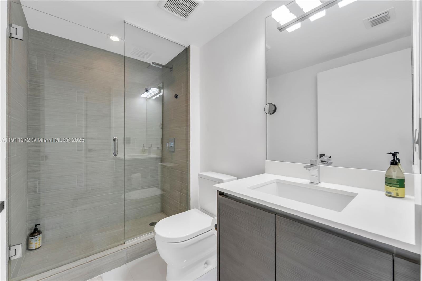 300 Sunny Isles Boulevard, Unit 4905 Sunny Isles Beach, FL 33160 - Photo 18 of 35 a bathroom with a sink a toilet and shower