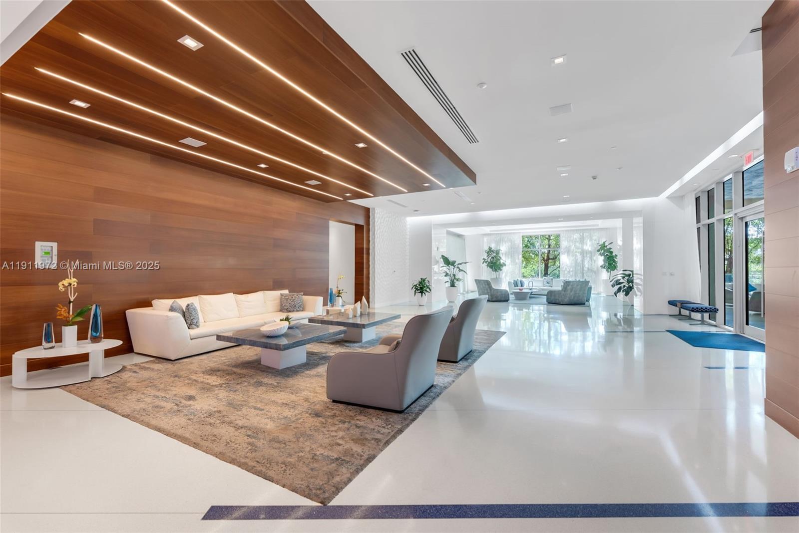 300 Sunny Isles Boulevard, Unit 4905 Sunny Isles Beach, FL 33160 - Photo 22 of 35 a living room with fireplace furniture and a view of kitchen