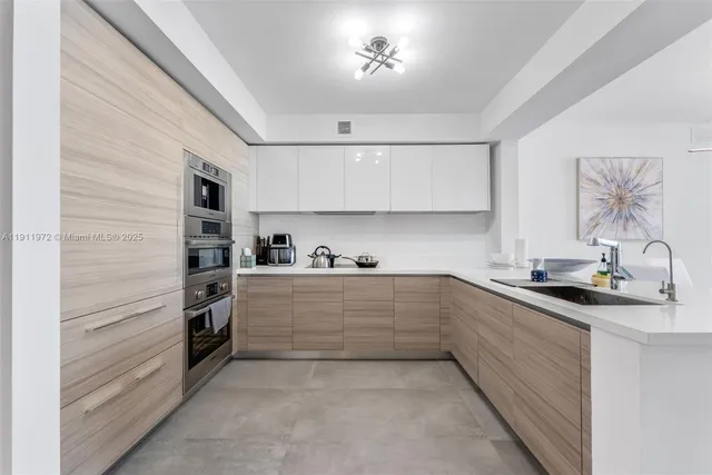 a kitchen with granite countertop a sink and cabinets