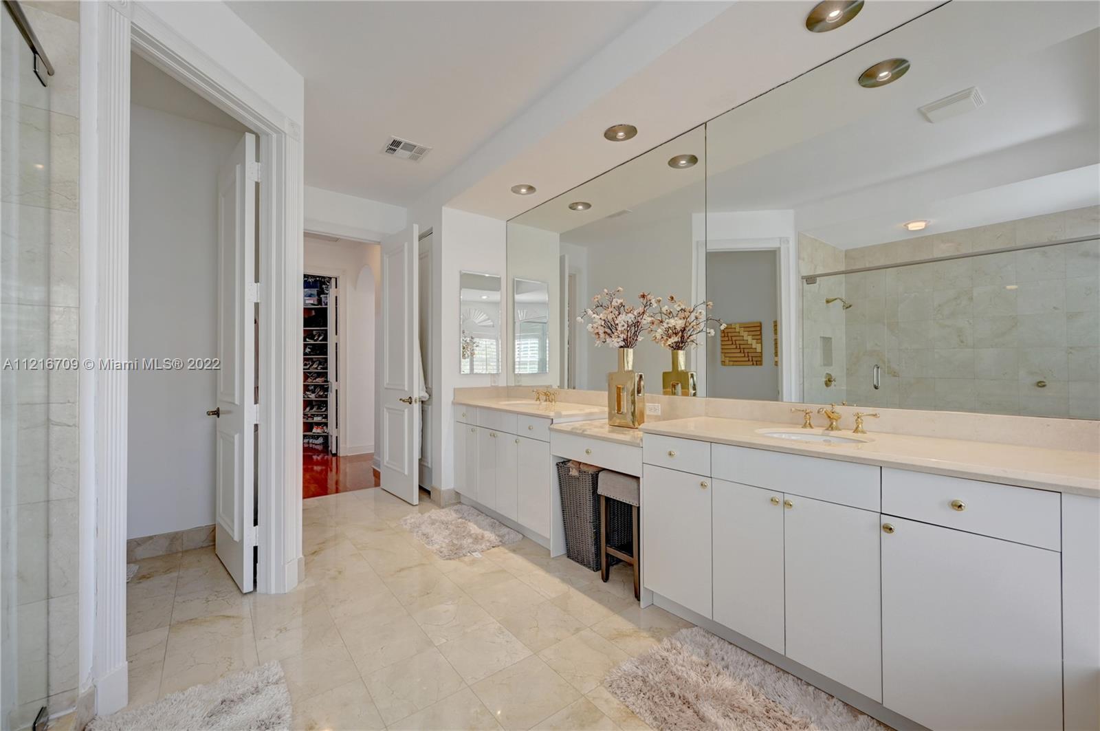 a spacious bathroom with a granite countertop sink mirror and a