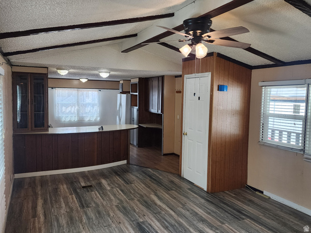332 Joshua Street Tooele, UT 84074 - Photo 2 of 16 Open-concept living area with wood-finish flooring, a ceiling fan with integrated lighting, and exposed ceiling beams