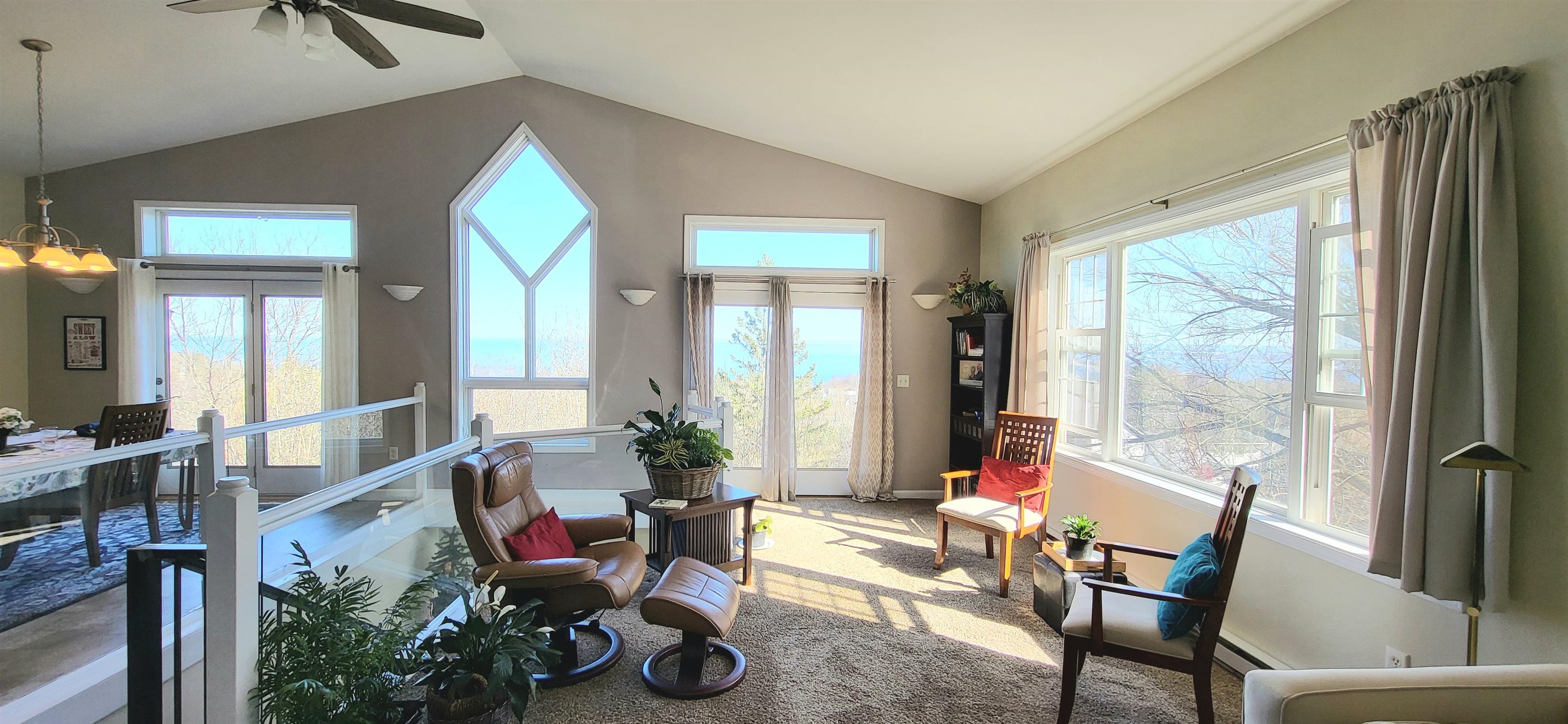 908 East Skyline Parkway Duluth, MN 55805 - Photo 12 of 40 Open living room with vaulted ceiling, a ceiling fan, and amazing views