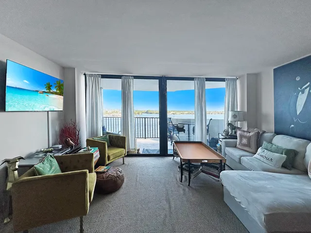 a living room with furniture and floor to ceiling windows