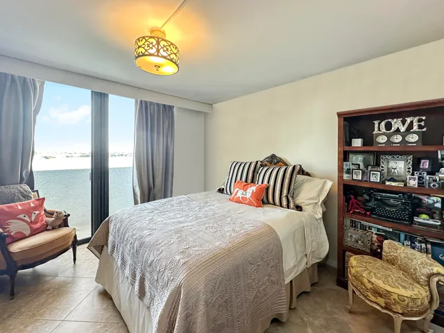 a bathroom with a granite countertop sink a mirror and a toilet