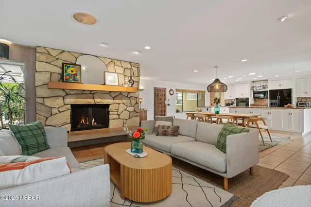 a living room with furniture and a fireplace