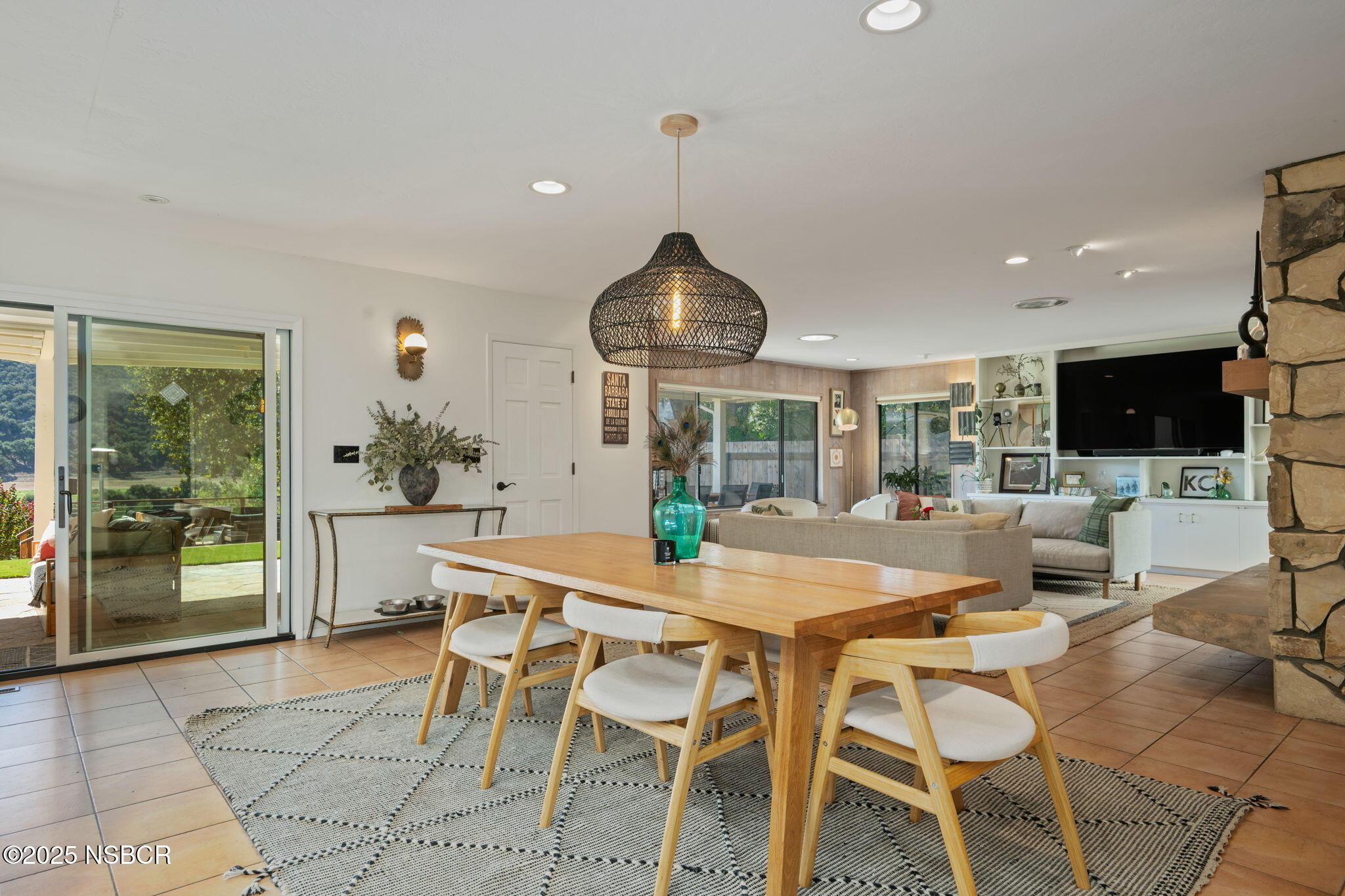 137 3rd Street Solvang, CA 93463 - Photo 13 of 48 a kitchen with stainless steel appliances kitchen island granite countertop a dining table chairs and white cabinets