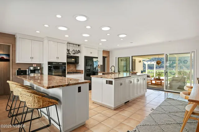 a large kitchen with lots of counter top space and stainless steel appliances