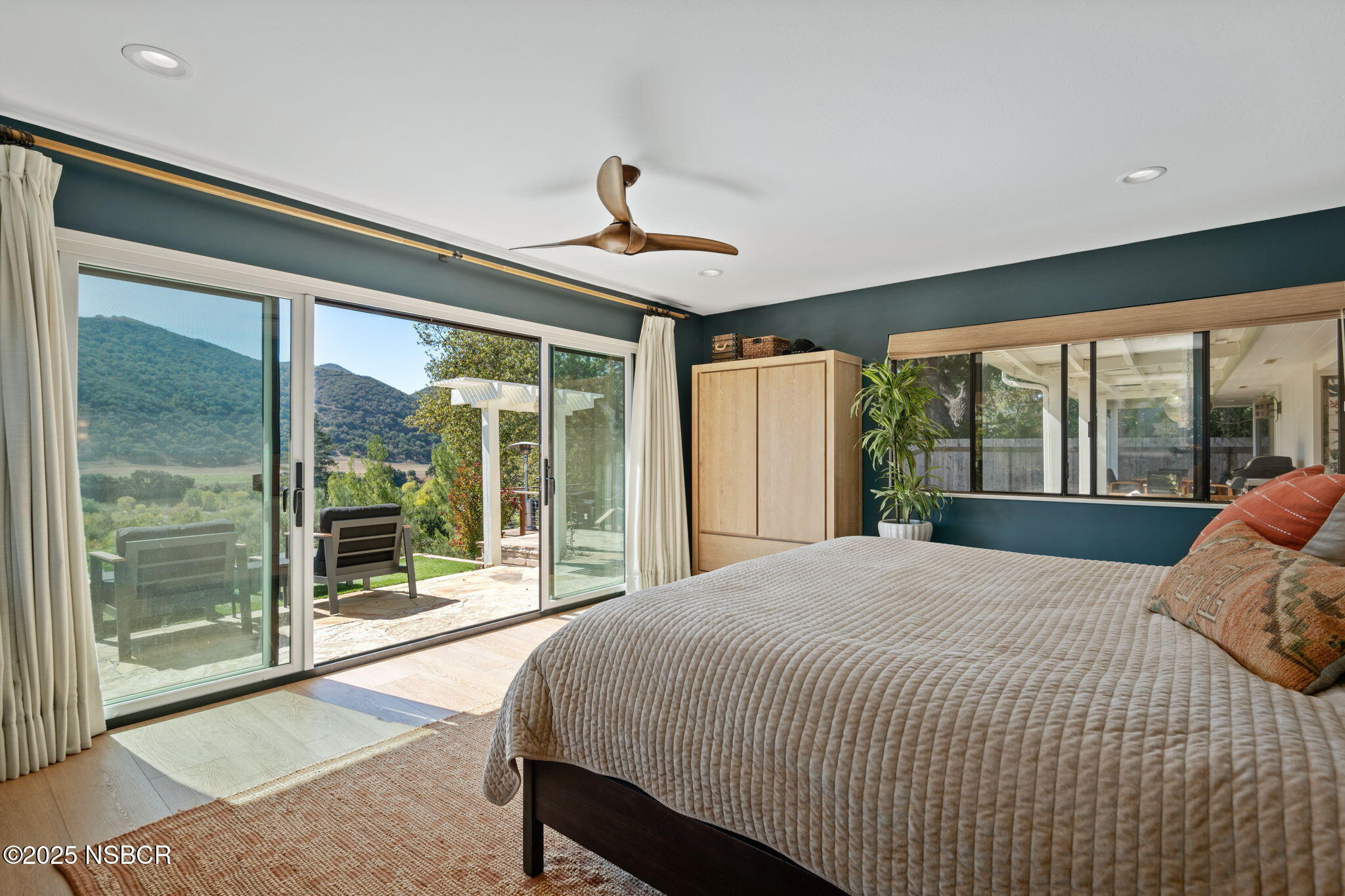 137 3rd Street Solvang, CA 93463 - Photo 20 of 48 a bed sitting in a spacious bedroom next to a large window