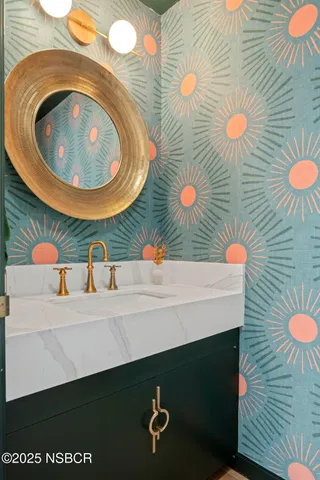 a bathroom with a sink mirror vanity and toilet