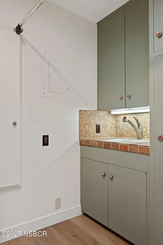 a bathroom with a sink and cabinets