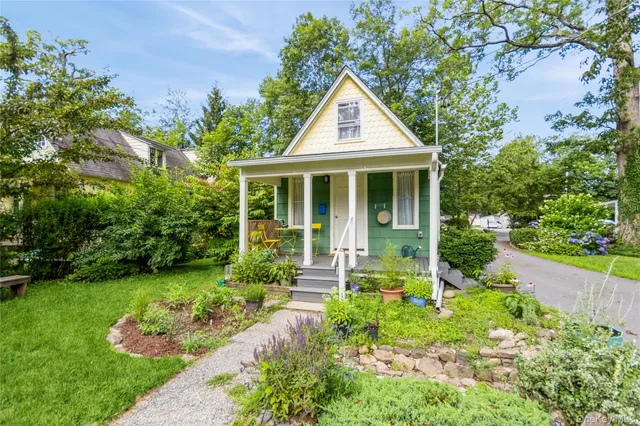 a front view of a house with garden